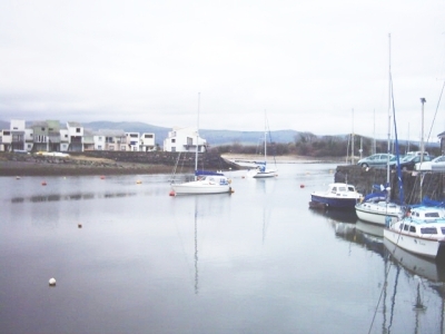 porthmadog harbour, boats and houses along the harbour wall
